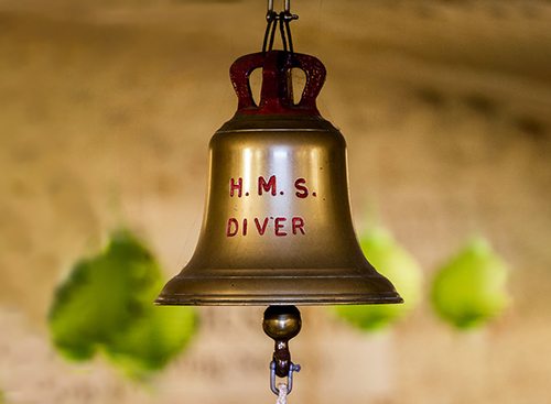 Image of a ship's bell with the words HMS Diver