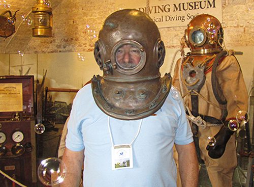 Image of a volunteer wearing an early diving helmet