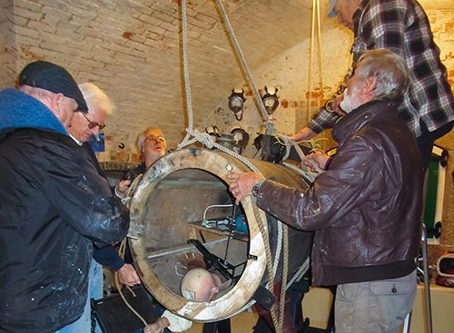 Image of volunteers installing an exhibit in the museum