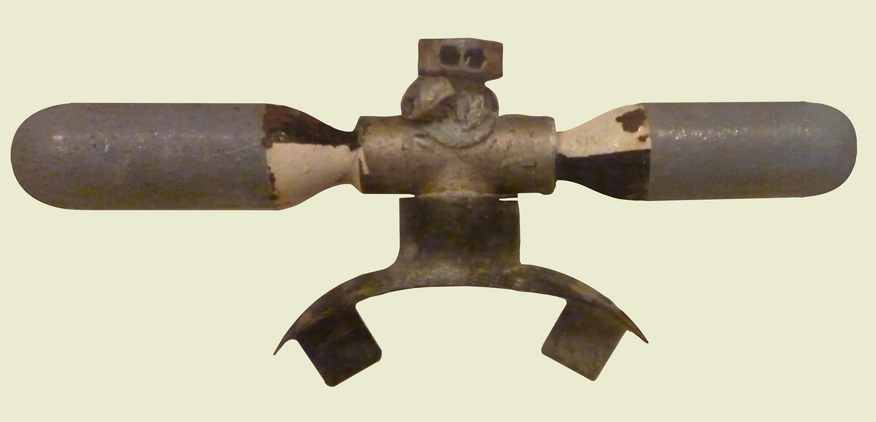 A mouthpiece from a diving regulator to which is attached two tiny grey cylinders each only about 8cm long