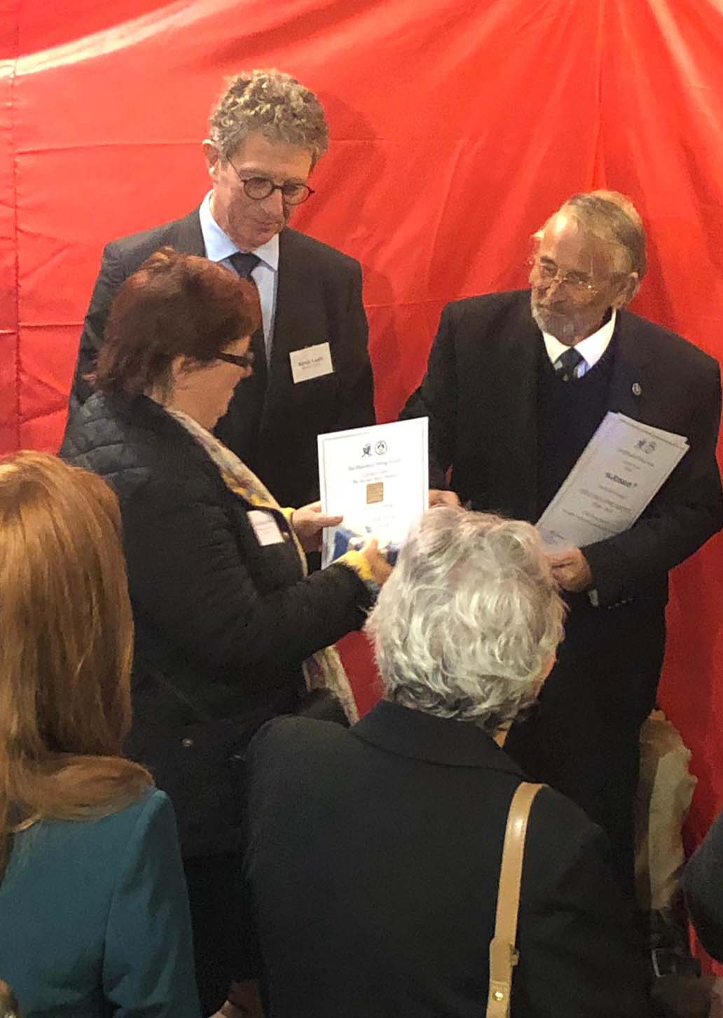 Gail Stewart-Bye, Senior curator at the National Motor Museum receives a certificate of appreciation from Dr John Bevan, chairman of the Historical Diving Society