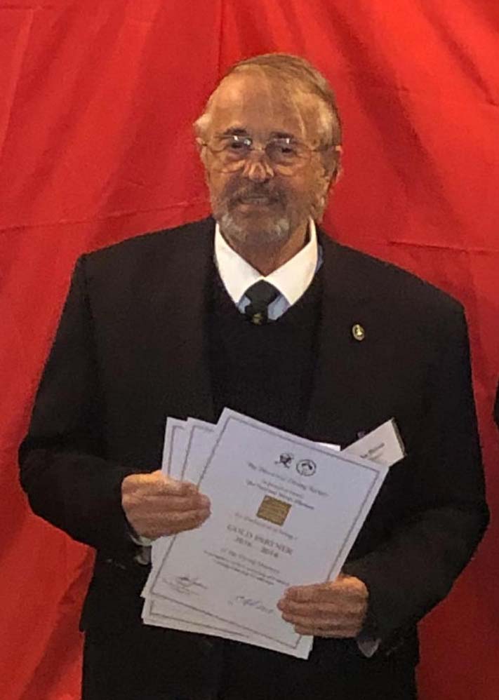 Chairman of the Historical Diving Society, dR John Bevan holding certificates he is about to present to our supporters.