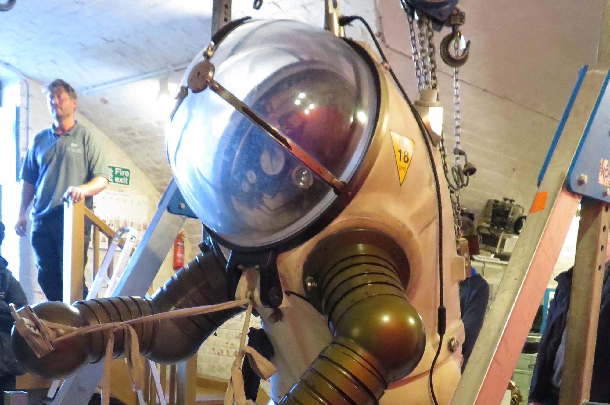 Upper body of a JIM suit showing the large Plexiglas dome and jointed arms of the man-shaped submersible