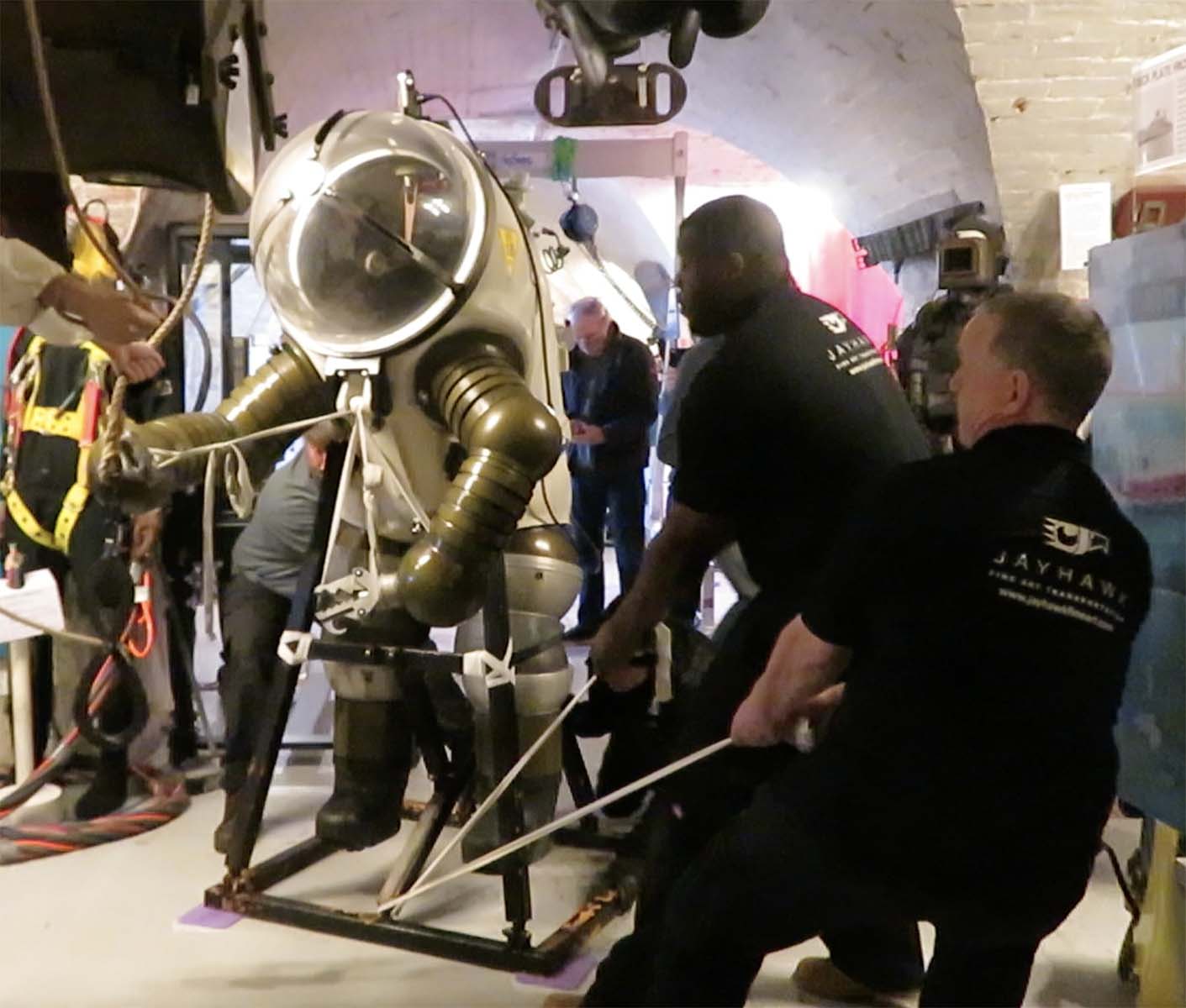 Front view of Jim being pulled by into position using strops and sliding pads beneath its display frame.