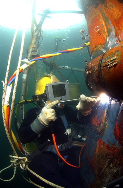 Professional diver welding underwater