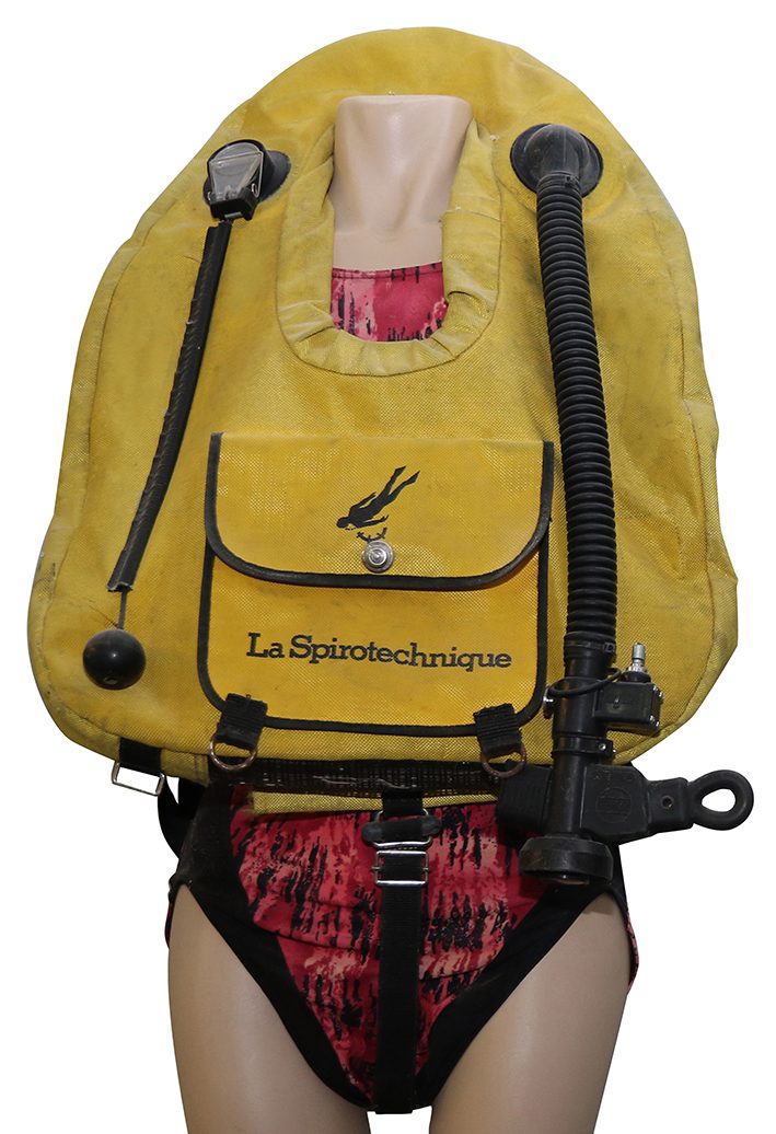 Mannequin wearing yellow ABLJ with black hoses and front pouch. Imagine a pillow with a hole near one end to put your head through.