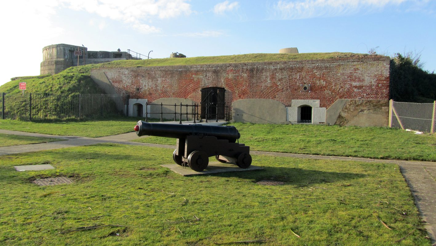 View of the front of entrance to the Diving Museum, a Victorian gun battery with a cannon in the foreground